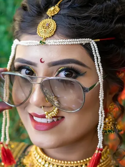 A fun and modern twist on a traditional bridal pose. This shows that while the makeup is classic, the bride's personality can shine through.