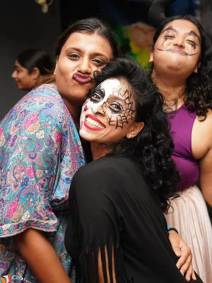Making funny faces and having a great time with friends during our Halloween event. It's all about letting go and being yourself.