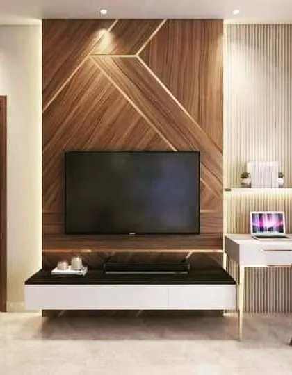 A TV unit that doubles as a workspace. This design combines a wood-paneled TV wall with an attached study desk, making it a perfect solution for a modern bedroom or home office.