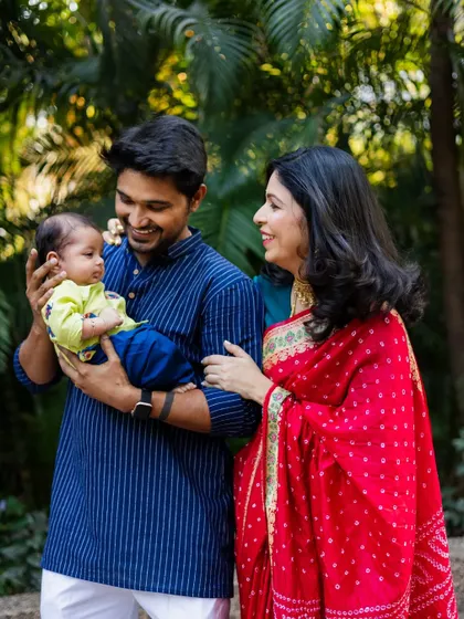 A candid moment of smiles and admiration between new parents and their baby. These natural interactions make for the most heartwarming family photos.