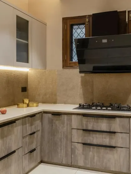The kitchen features a U-shaped layout with ample counter space and under-cabinet lighting for a bright and functional cooking environment.