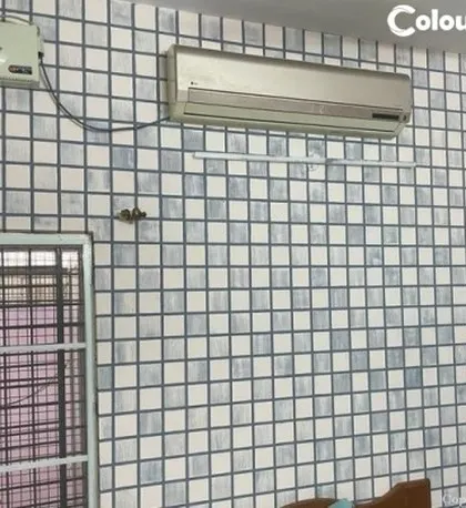This wall features a simple grid texture, creating a tiled effect with paint. It's a great way to add a geometric pattern and visual interest to a room in a clean and understated manner.