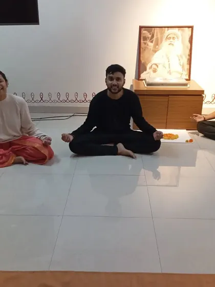A group sits together after a powerful Surya Kriya session, basking in the energy of the practice and the presence of the Guru.