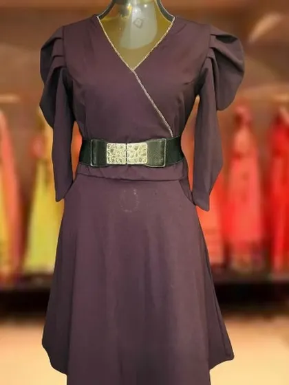 This dark purple wrap-style dress features puff sleeves and a wide belt. It's a versatile and fashionable choice that works well for both daytime and evening events.