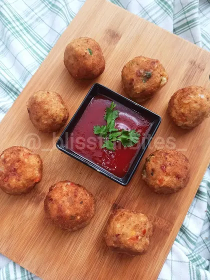 My popular Chicken Cheese Shots, beautifully arranged on a wooden board with a tangy dipping sauce. These are available ready-to-fry and are a favorite among kids and adults alike.