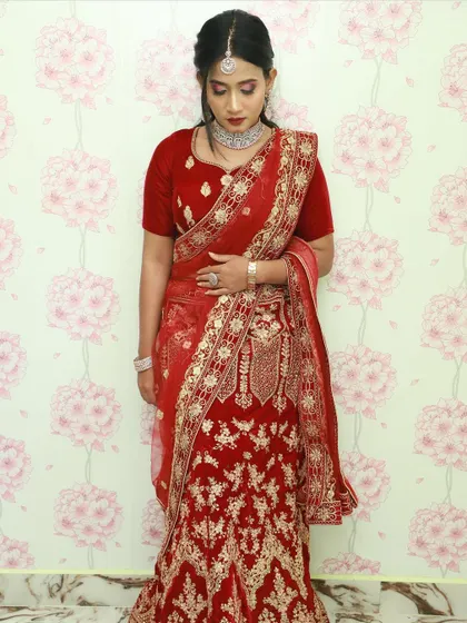 A detailed shot showcasing the drape of the dupatta and the intricate patterns on the lehenga skirt.