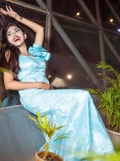A joyful, laughing shot of the model in the light blue gown.