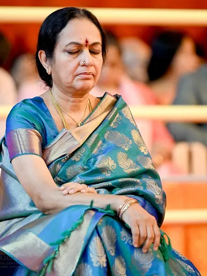 A participant sits in deep meditation during our Navratri celebrations. These nine nights are a powerful time for spiritual practices, and many join us to experience profound transformation.