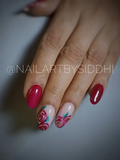 A classic and elegant design with two accent nails featuring hand-painted deep red roses, paired with solid maroon nails.