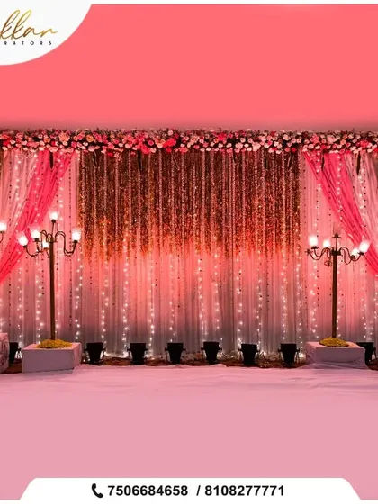 A glamorous stage backdrop with shimmering curtains and vintage-style street lamps. The floral border in shades of pink adds a soft, romantic touch.