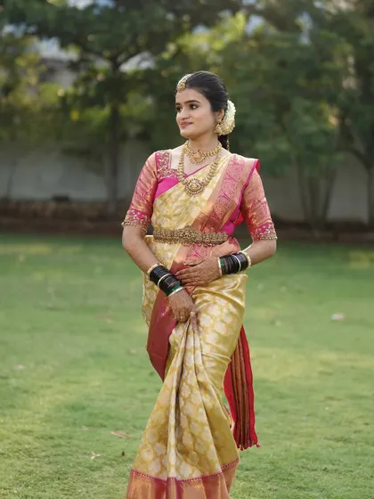 A full length shot showcasing the beautiful drape of the Kanjivaram saree and the overall bridal look.