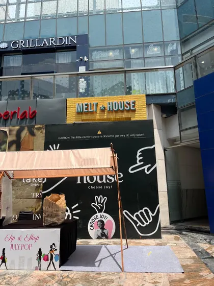 The exterior of the Melt House cafe during construction, with the signage up and hoarding promising something exciting to come. This marks a key milestone in the project's journey from concept to reality.