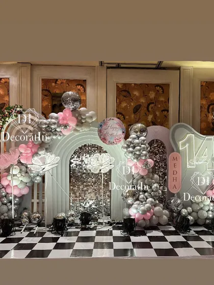 A wider view of the glamorous 14th birthday setup, showing the full extent of the sequin walls and balloon decor on the checkered floor.