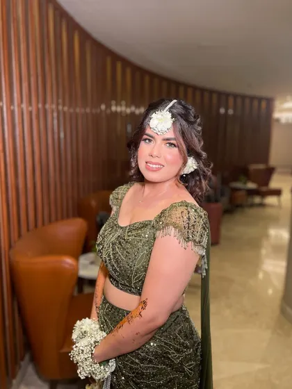 Green and gorgeous! My beautiful bride Simi chose a dreamy Mehendi look with an olive green lehenga and floral jewelry. The makeup was kept soft and glowing to complete the magical vibe.