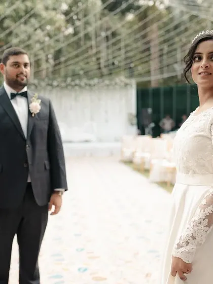 A beautiful shot of the bride walking down the aisle towards her groom for their first look.