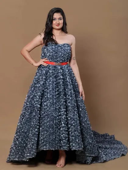 A full-frontal view of the grey high-low gown, accented with a bold red belt.