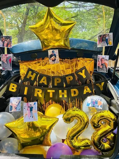Another view of the photo-filled car boot, showing the large star-shaped foil balloons.