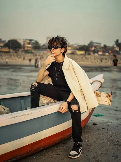 A thoughtful pose that adds a story-telling element to the men's beach shoot.