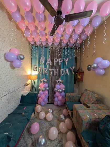 This shot captures the full effect of the ceiling balloons with hanging ribbons, creating a curtain of color.