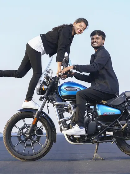A fun and playful moment from a pre-wedding shoot on a bright blue Royal Enfield motorcycle. I always encourage couples to bring their personality into the photos.