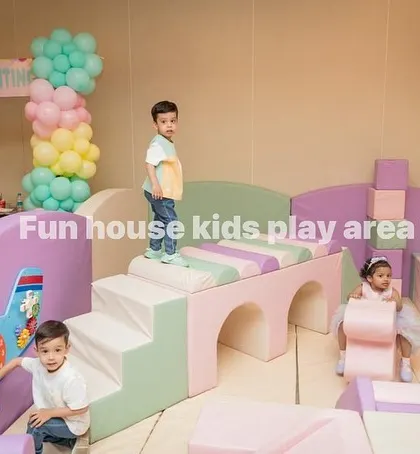 Kids exploring the pastel bridge and activity wall. Our play areas include various elements to develop motor skills.