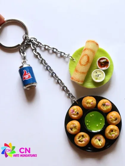 An assorted keychain featuring pani puri and dosa, a perfect gift for a street food lover.