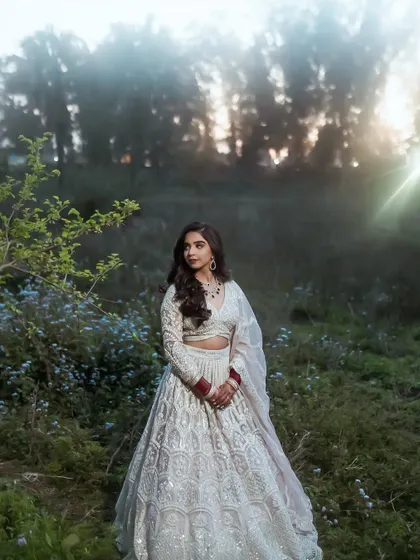 This outdoor shot with the sun flare is magical. Her reception makeup looks stunning in the fading light.
