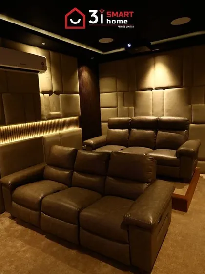 This 7.2.2 luxury home cinema in Dindigul is a masterclass in creating a warm and enveloping atmosphere, using quilted, earth-toned acoustic panels and soft, indirect lighting.