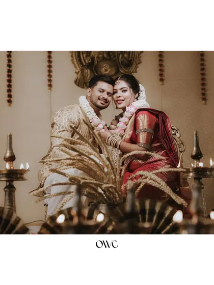 A stunning portrait of a couple during their wedding ceremony, surrounded by the warm glow of traditional lamps.