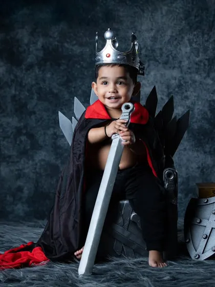 A royal portrait of our little king, complete with a crown, cape, and sword. He looks ready to defend his kingdom.