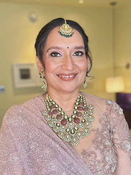 The mother of the bride looks happy and confident. The makeup is designed to be flattering and timeless.