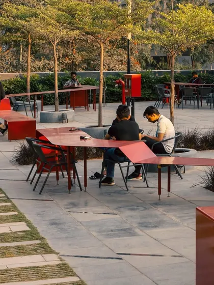 The undulating form of the Red Ribbon creates informal zones for dining and socializing. It's a perfect example of how we design "people spaces" that are not just functional but also add a playful, artistic element to the landscape.