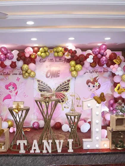 A fairytale theme with butterfly accents, using a rich color palette of pink, maroon, and gold.