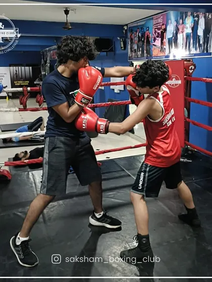 Partner drills are a fundamental part of our training. Here, two young boxers work on their technique, building skills and camaraderie in the ring.