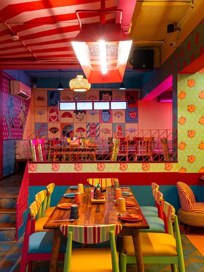 A multi-level shot of The Fatty Bao's interior, showing the relationship between the ground floor and the mezzanine. This architectural photograph highlights the dynamic use of a compact space.