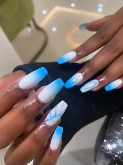 A cool and refreshing blue and white ombré on long coffin nails, with a delicate blue marble accent nail.