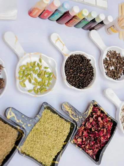 A close-up of the beautiful ingredients for the candle-making station, including dried flowers, spices, and various scents.