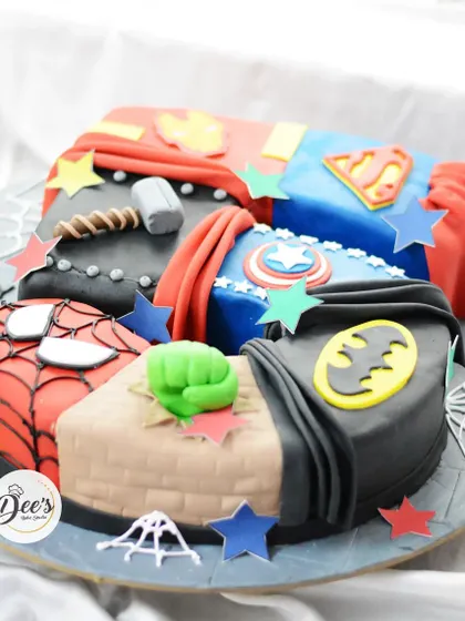 A side view of the superhero number cake, showing the different textures and layers of fondant that create the superhero costumes.