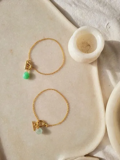 A close-up of the melon toggle bracelets, showing the unique cut of the stones.