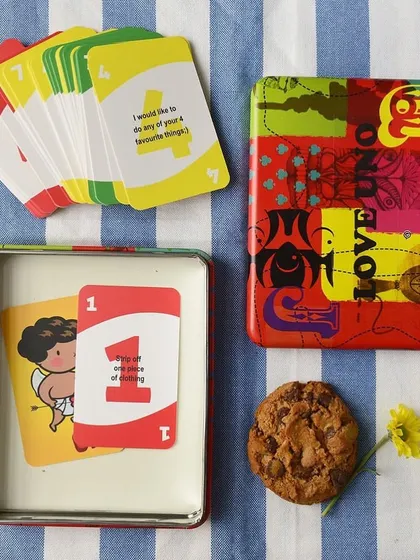 The "Love Uno" game is a great pocket-friendly gift to bring a smile to someone's face, shown here with its vibrant, pop-art style tin.