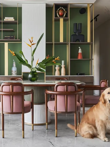 The "Whimsical House" dining area, where our 'Pellet Drum' table and 'Svelte' chairs create a vibrant and artistic setting. The space is made even more lively by the family's golden retriever, a reminder that our homes are for living in.
