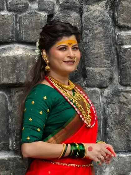 A smiling, confident shot of Savaniee in her full traditional attire for the music video.