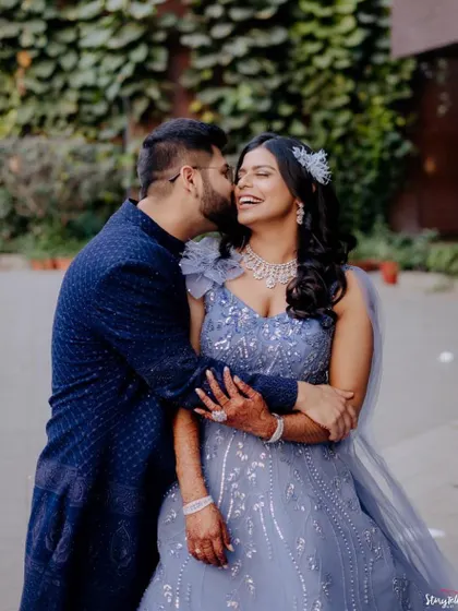 A romantic couple shot from a reception. The bride's makeup is glamorous and modern, perfect for this happy moment.