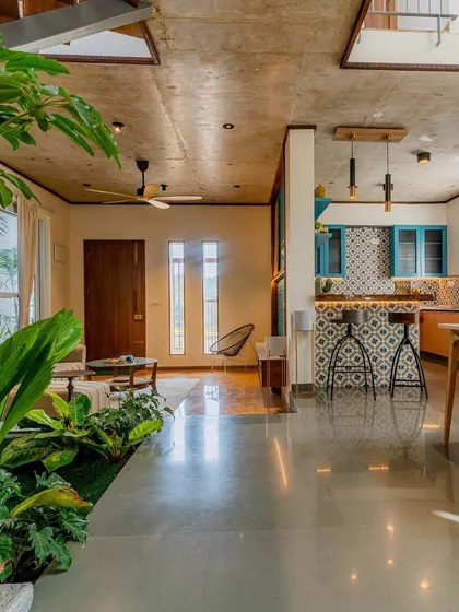 An open-plan living space from 'The Valley' project, where an indoor garden is the heart of the home. This biophilic interior design approach brings life and tranquility into the daily living experience.