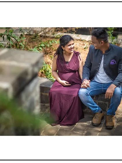 A quiet, seated moment of connection between the expecting parents.