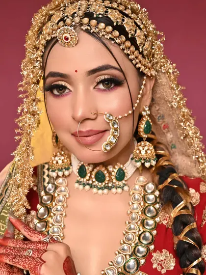 A gorgeous close-up that captures the glow on the skin and the sparkle in the eyes. The lip color perfectly complements the red in the outfit.