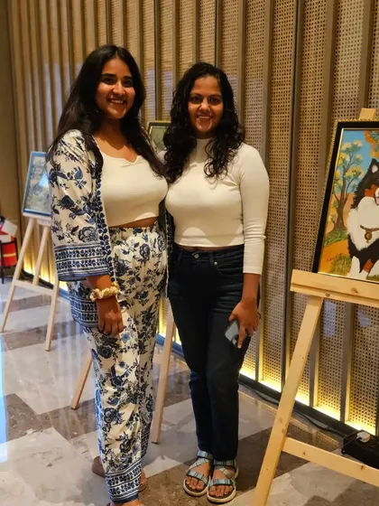 Visitors at the 'Art Soirée', enjoying the collection of paintings by Badrunissa Irfan.