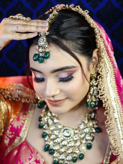 A close-up on the maang tikka and eye makeup, demonstrating the student's precision and attention to detail.