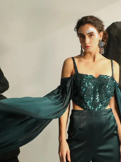 An example of my work in high-fashion and occasion wear. This shot captures the movement and drama of the garment, with a focus on the embellished, off-shoulder top and flowing sleeves, creating an ethereal and powerful look.