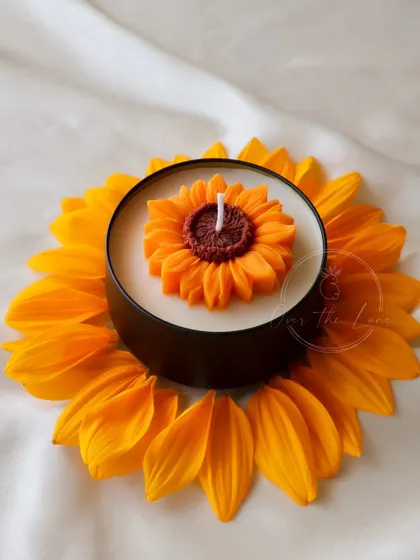 Another shot of the Sunflower tin candle, framed by real sunflower petals.